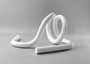 White sculpture laying on the floor with two loops