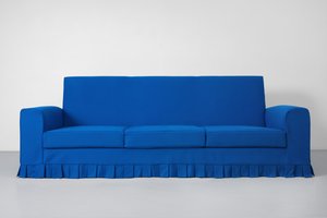 Blue sofa with ruffles on the bottom