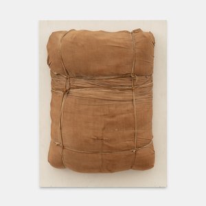 Wrapped fabric with rope and twine mounted on a wood board