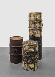 Three oil barrels with two wrapped in fabric