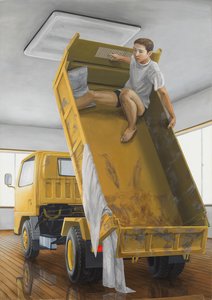 A man bracing himself at the top of a raised yellow truck bed